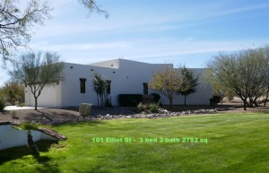 Modern white house with green lawn