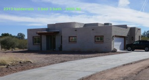 Modern desert home with car parked outside