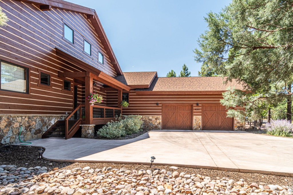 Rustic wooden house with garage and driveway