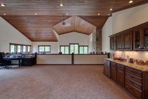 Spacious room with wooden ceiling and cabinets