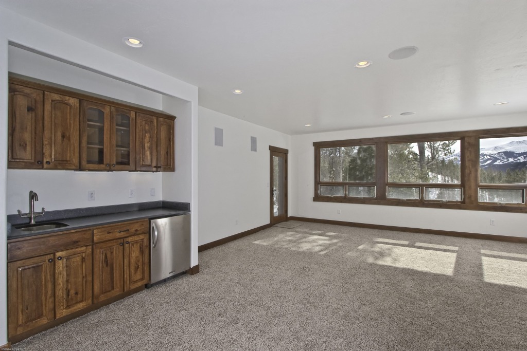 Spacious room with wooden cabinets and large windows
