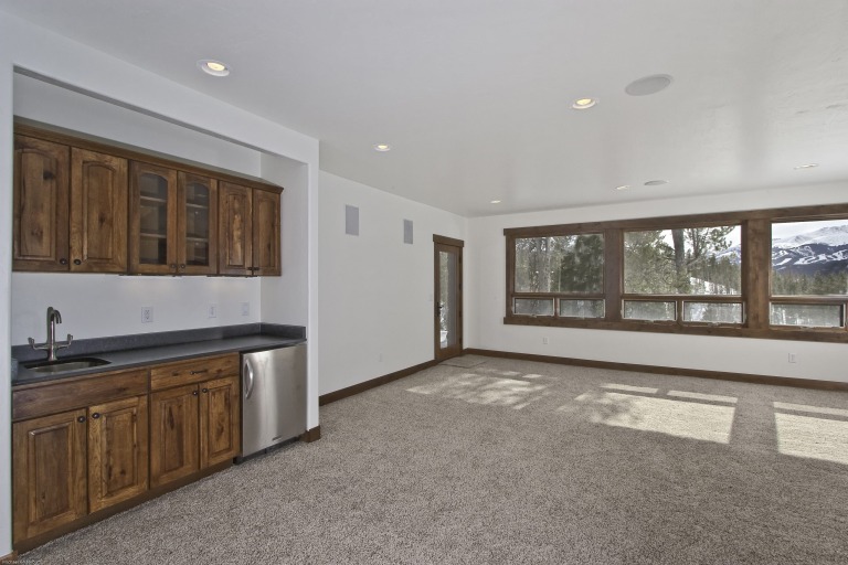 Spacious room with wooden cabinets and large windows