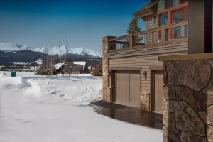 Snow-covered mountains behind a modern house.