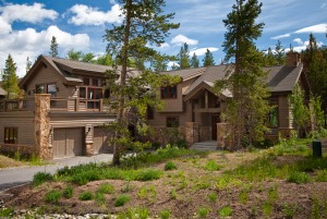 Rustic wooden house in forest setting.