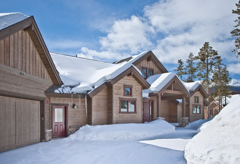 Snowy mountain cabin with wood exterior.