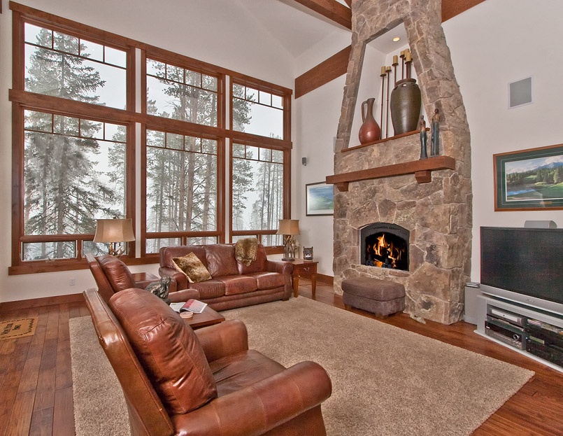 Cozy living room with large windows and fireplace