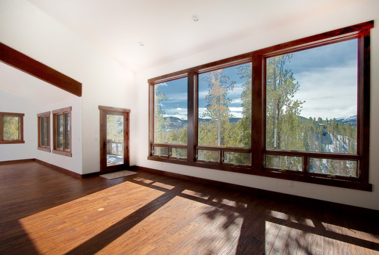 Spacious room with large windows and hardwood floors