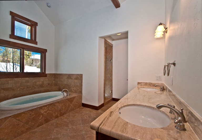 Modern bathroom with tub and double sinks