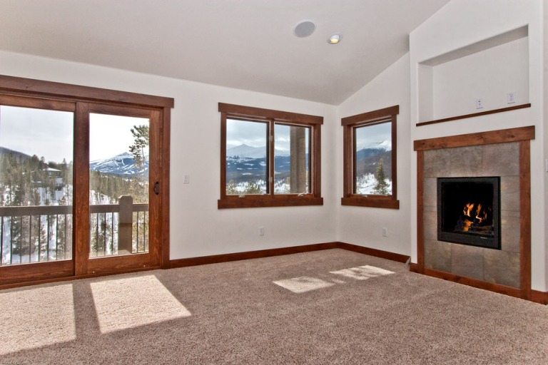 Cozy room with fireplace and mountain view