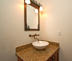 Rustic bathroom vanity with forest theme.