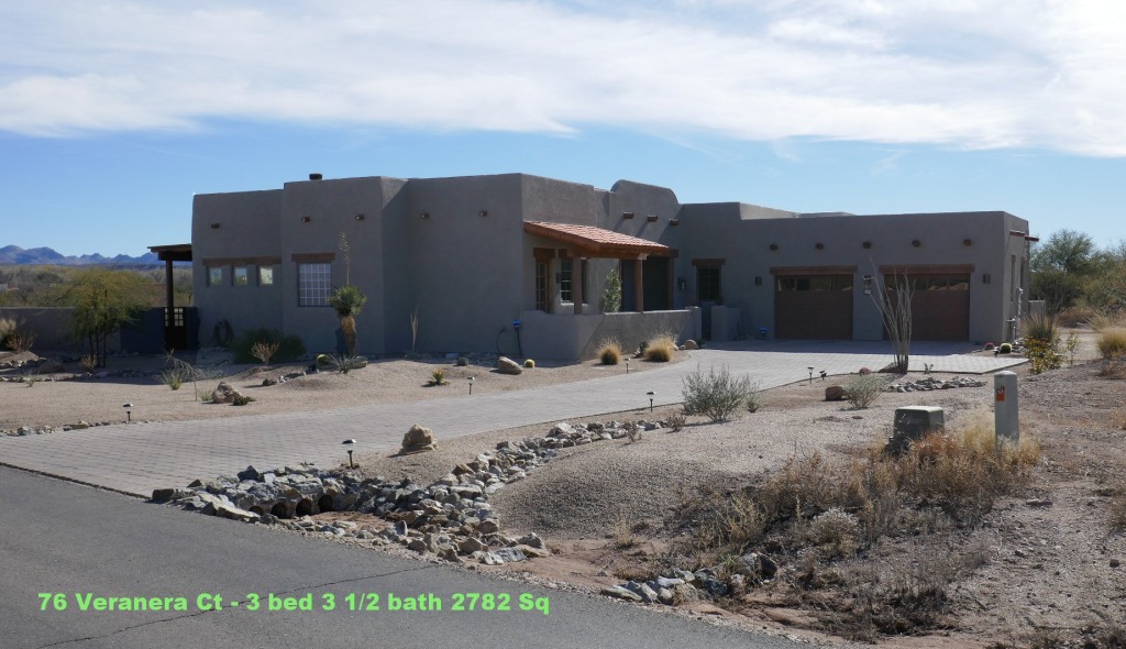 Modern adobe-style home with desert landscaping